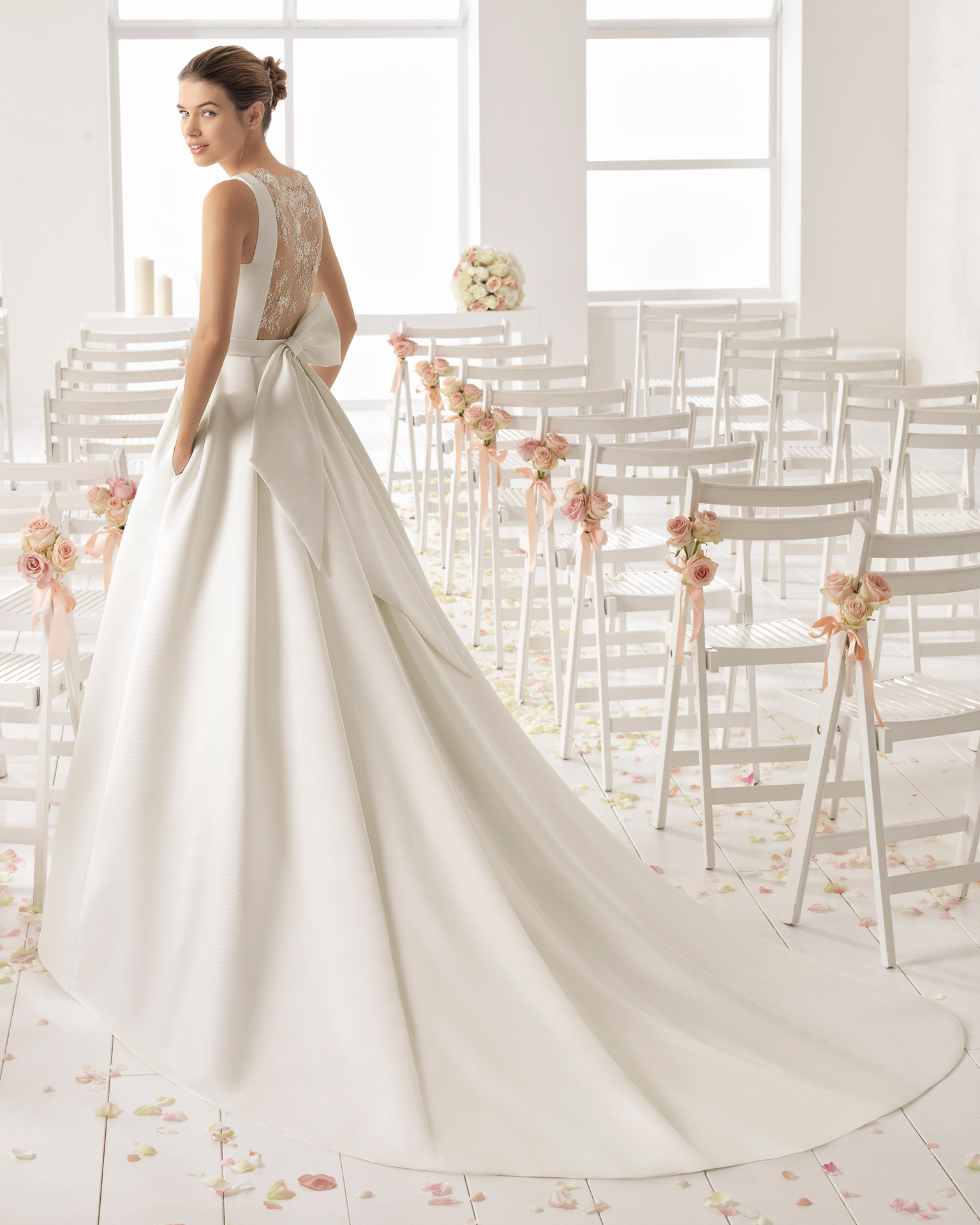 Classic-style Ottoman wedding dress with bateau neckline and beaded lace back.