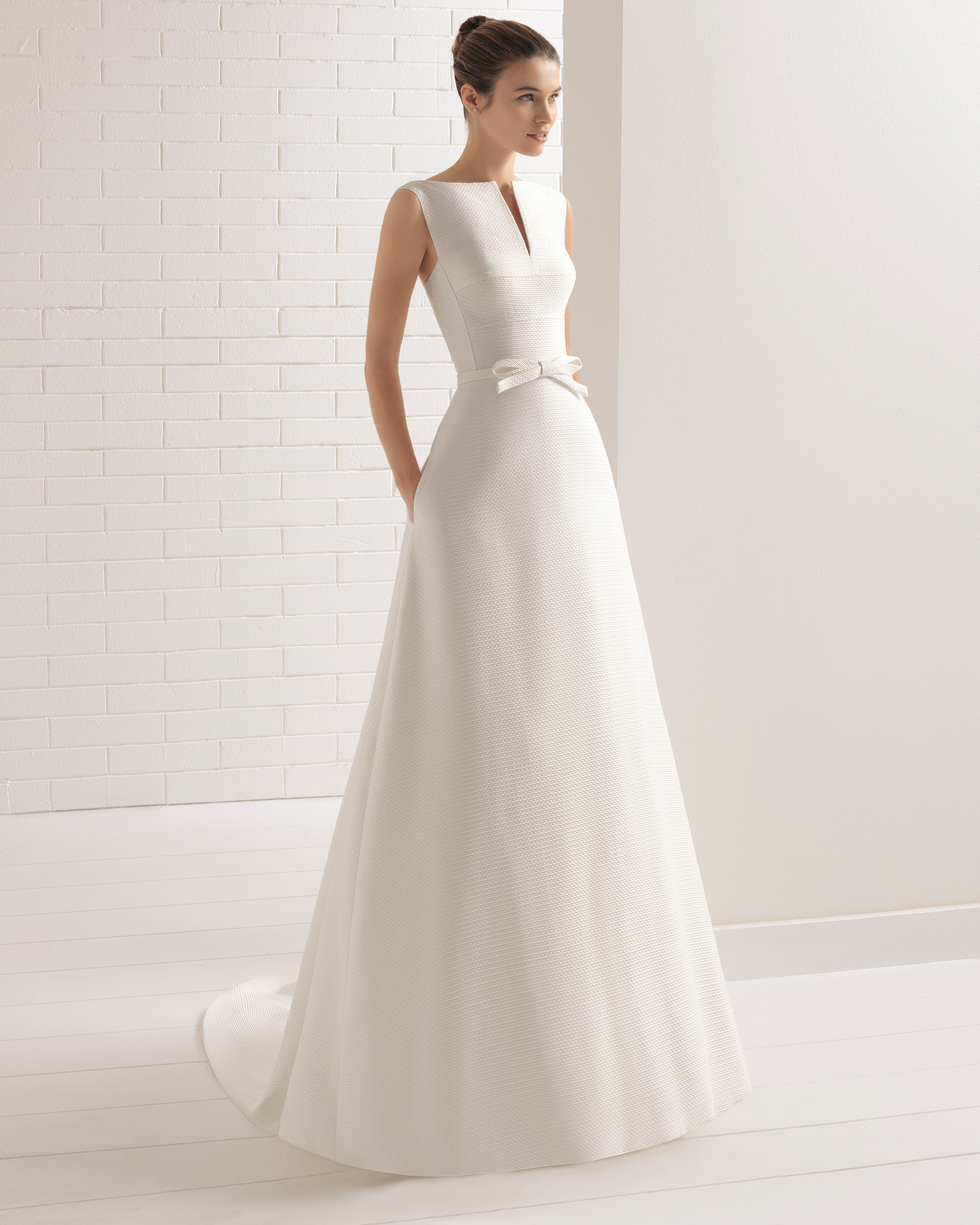 Classic-style capri wedding dress with bateau neckline, front opening and beadwork detail.