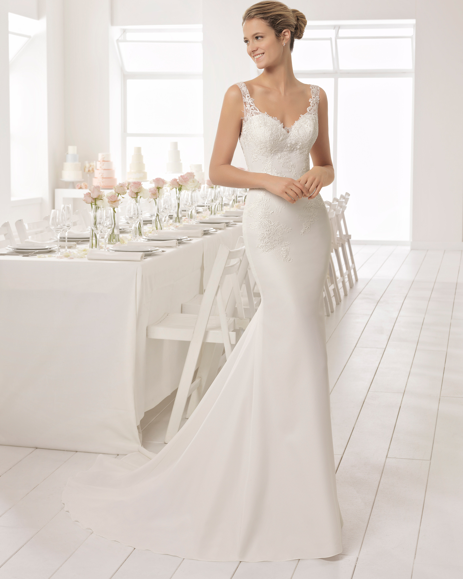 Classic-style beaded lace and crepe wedding dress with V-neckline and low back.