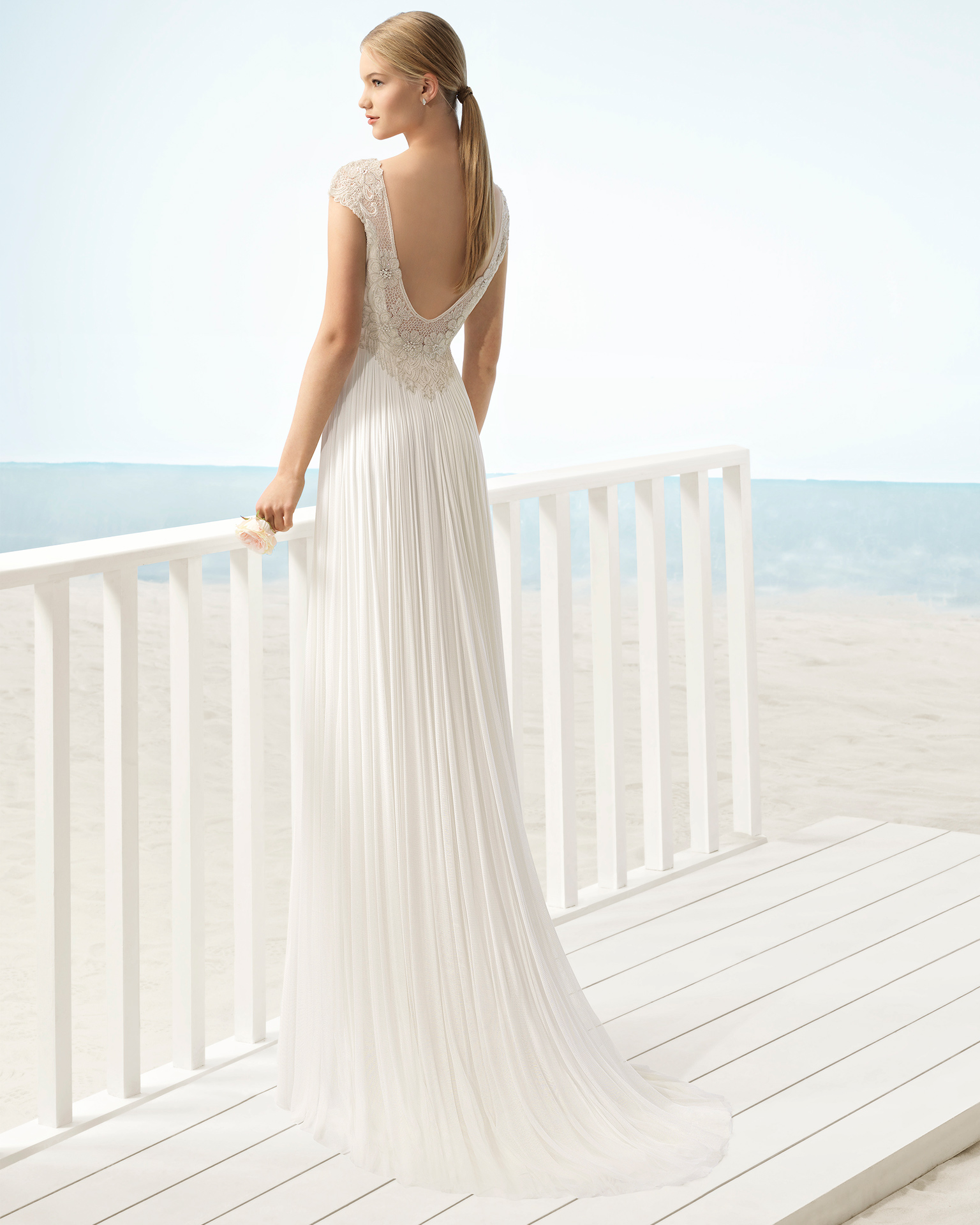 Boho-style silk mousseline wedding dress with bateau neckline and jeweled back.
