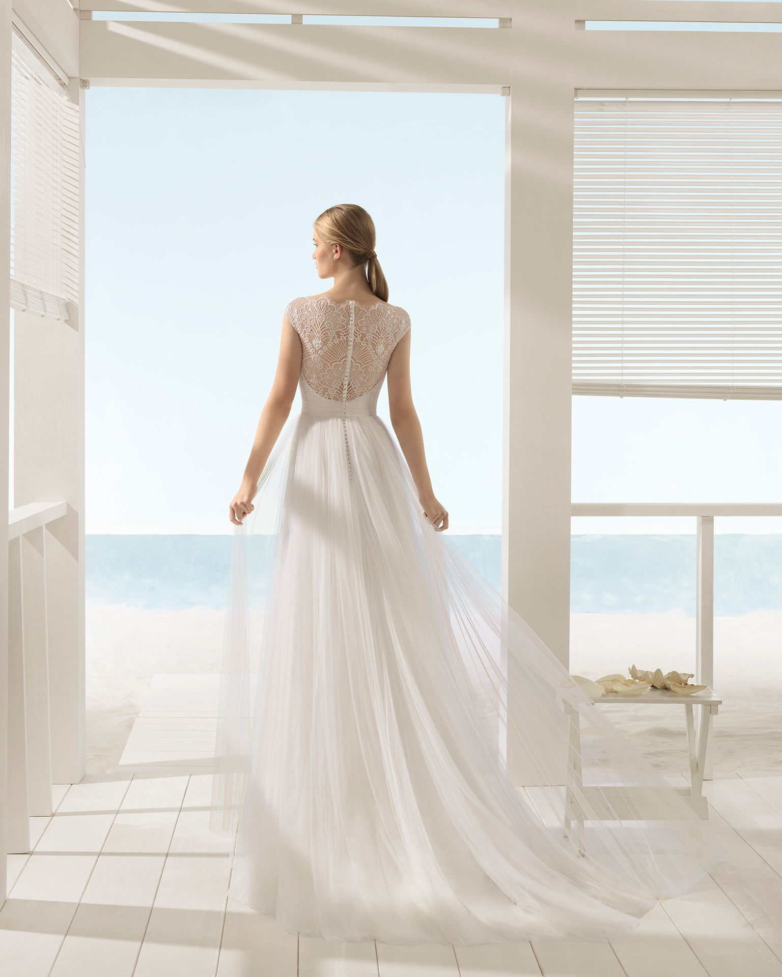 A-line beaded lace and tulle wedding dress with short sleeves and low back.