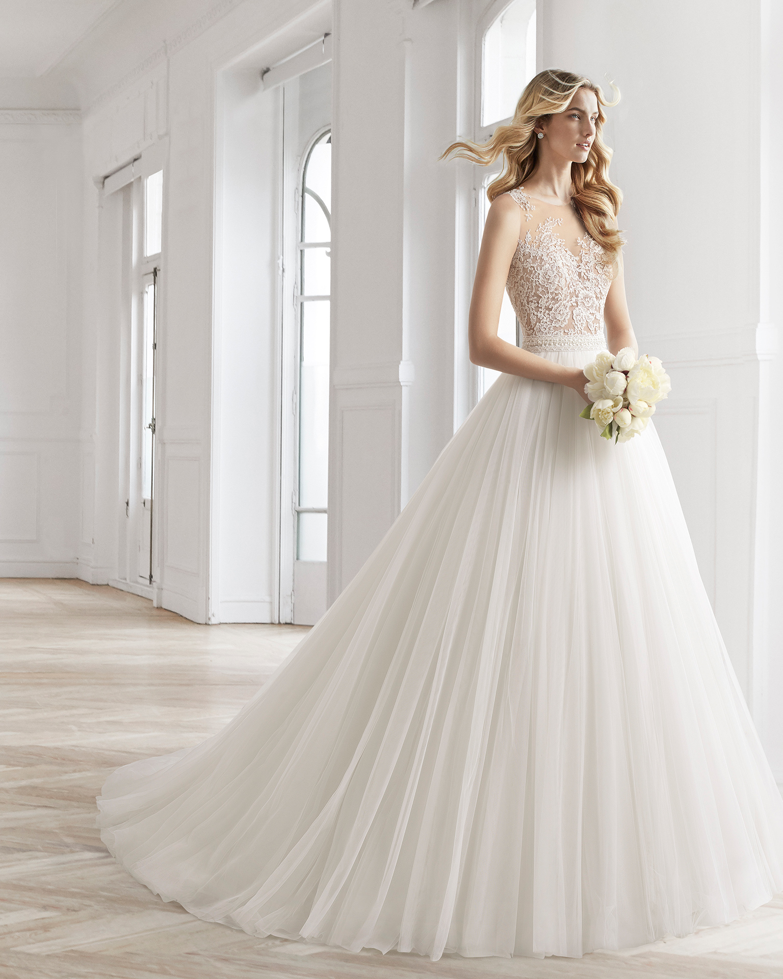 A-line beaded sheer lace and tulle wedding dress.